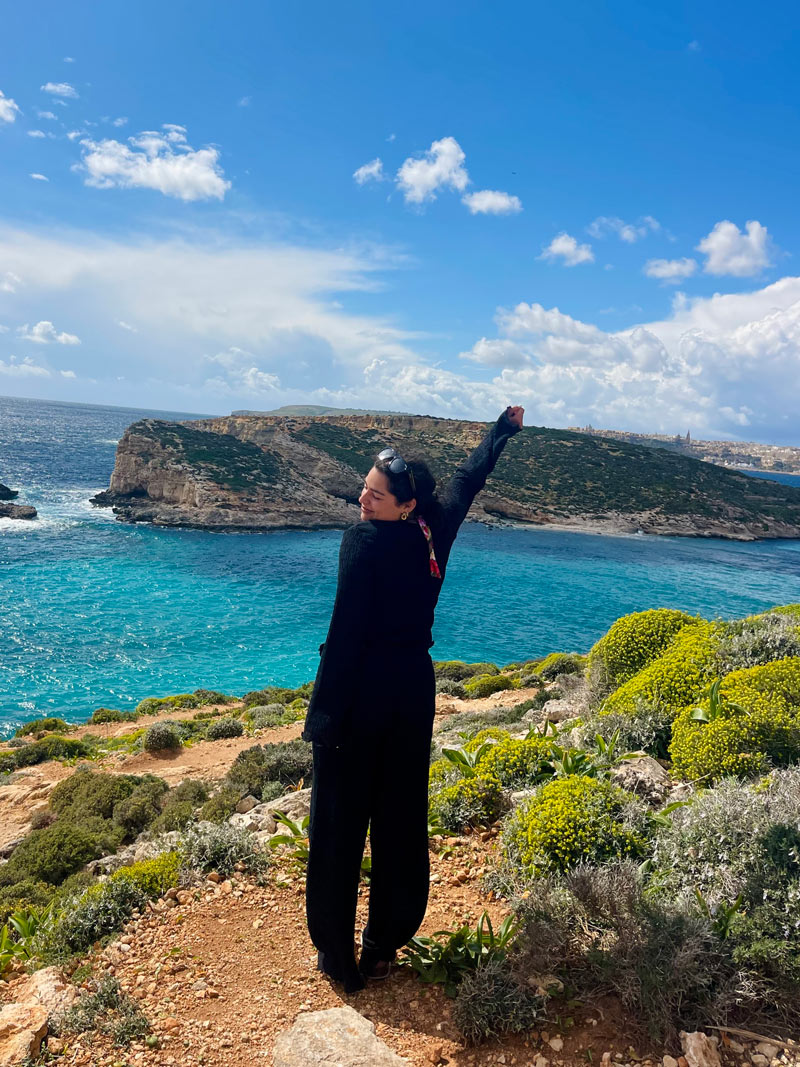 Erica standing near some seaside cliffs