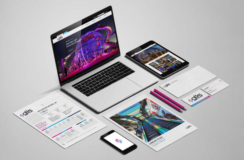 A mockup showcasing a variety of deliverables from GLLS's rebrand, including stationery, technical documents, and their new website.