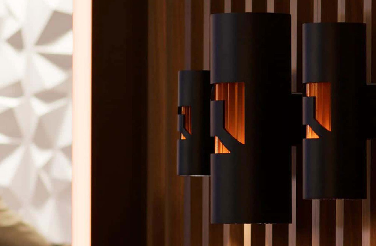 Three decorative wall sconces on display at Lightfair