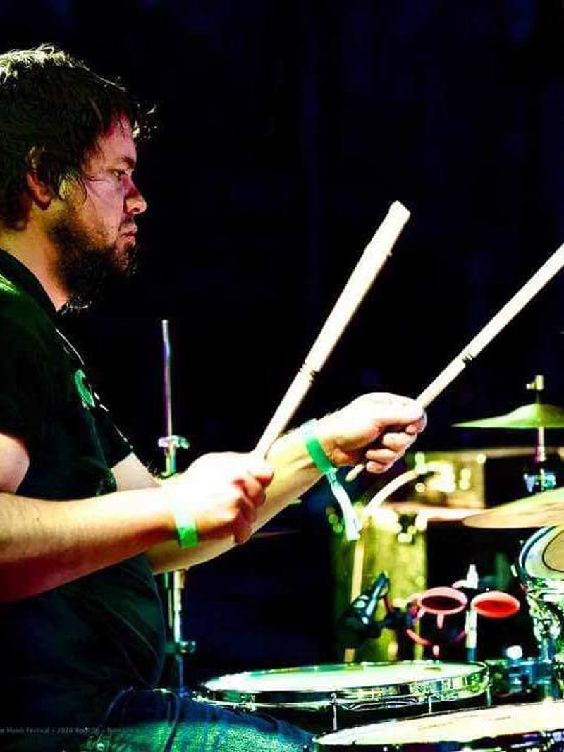 Tyler playing the drums at a concert