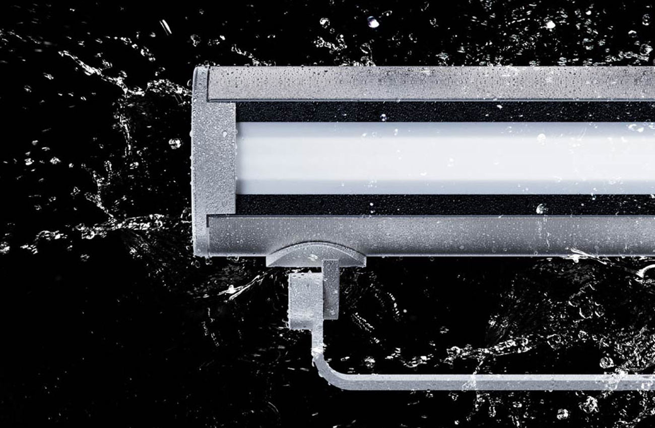 A rendering of a Vista 1050 Linear Series lighting product getting splashed with water